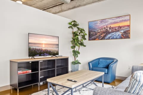 A cozy modern living room featuring a TV and comfortable seating.
