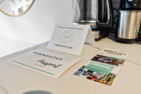 Promotional cards and brochure for Minnestay vacation rentals on a countertop