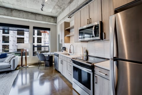 Modern kitchen with concrete ceilings and stylish furnishings.
