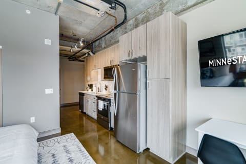 Interior view of a modern studio apartment with kitchen and living space.