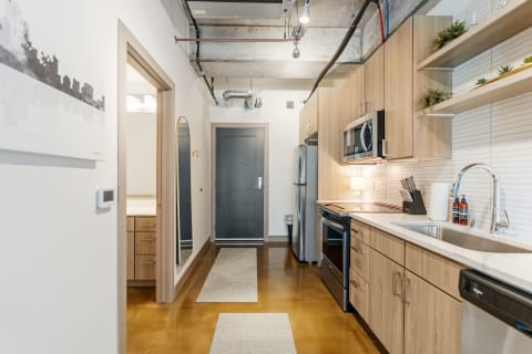 Modern kitchen interior with wooden cabinets and stainless steel appliances.