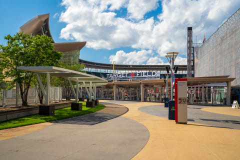 Exterior view of Target Field with lush greenery and a blue sky.