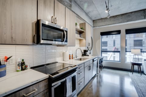 Contemporary kitchen with stainless-steel appliances and wood cabinetry.