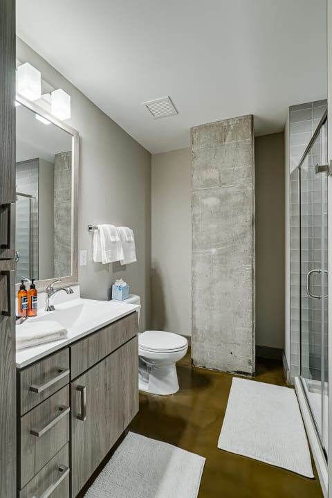 Contemporary bathroom with a gray color scheme and stylish fixtures.