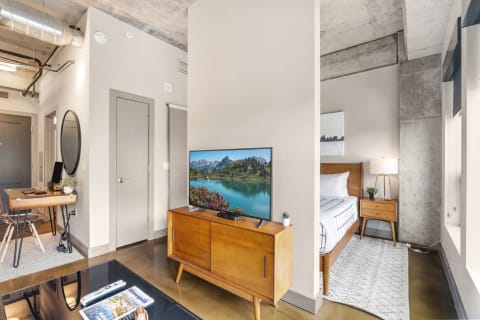 Interior view of a modern studio apartment featuring a living space and sleeping area.