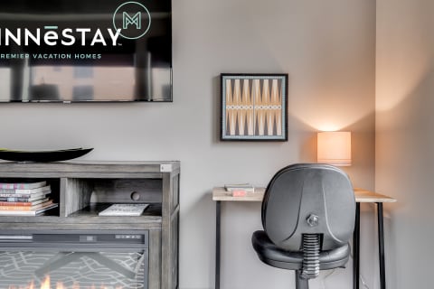 Contemporary living room with a workspace and stylish decor.