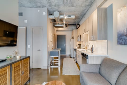 Interior view of a modern studio apartment with kitchen, living area, and stylish decor.