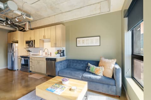 Interior of a modern studio apartment with kitchen and living area.