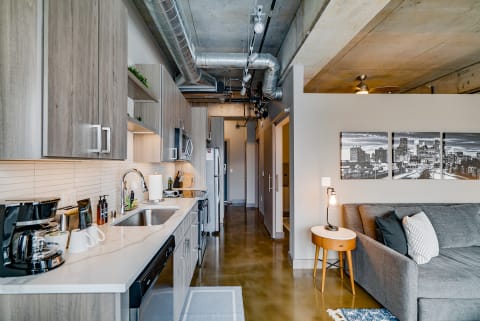 Interior view of a modern studio apartment showcasing a kitchen and living space.
