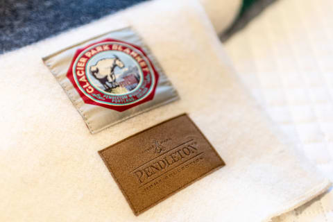 Close-up of a Pendleton blanket with Glacier Park blanket label and leather patch.