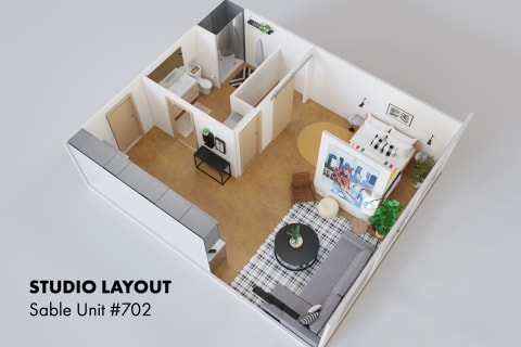 Top-down view of a studio apartment layout showing living space, kitchenette, and bathroom.