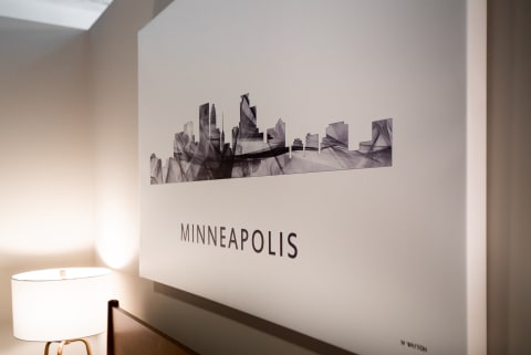 An abstract skyline art of Minneapolis featuring geometric shapes and the city name.