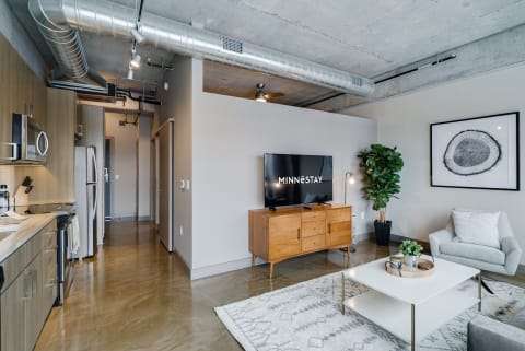 Contemporary apartment interior featuring a kitchen, living room area, and stylish furniture.