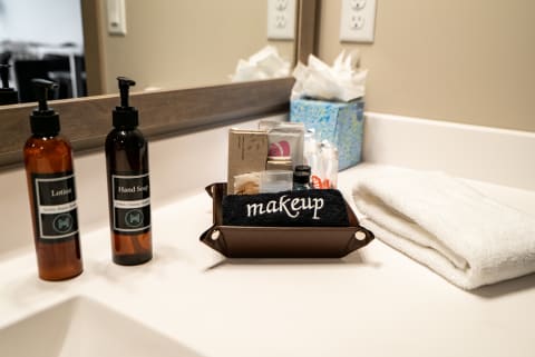 Organized bathroom countertop with lotion, hand soap, and makeup items.