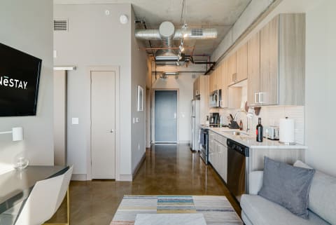 Interior view of a contemporary studio apartment with kitchen and living space.