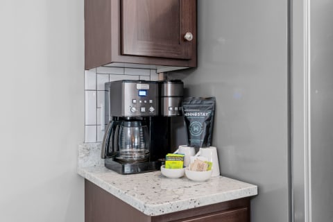 Coffee maker with a selection of tea and coffee on a countertop.