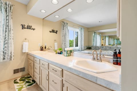 Modern bathroom with marble countertop and natural light.