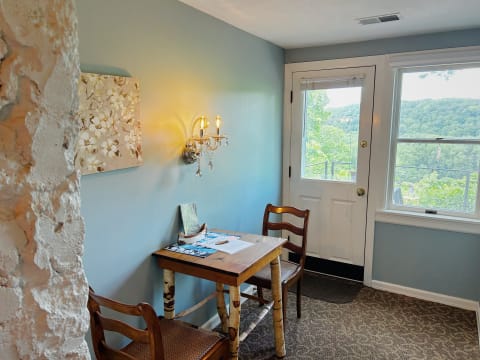Cozy workspace with wooden table and mountain view through the window.