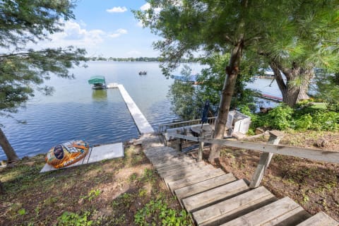 Stairs leading to a dock by the lake with a water toy visible.