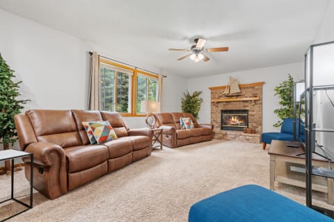 Inviting living room with brown leather recliners, a fireplace, and stylish decor.
