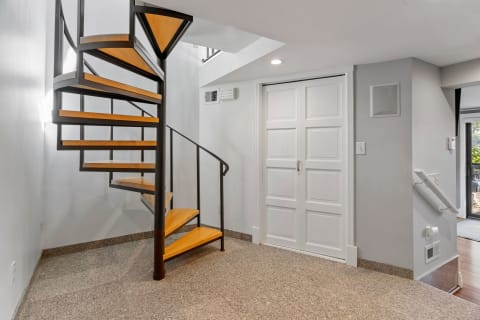 Interior view featuring a spiral staircase and double doors.