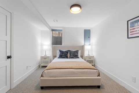 Cozy bedroom with a queen-sized bed and contemporary decor.