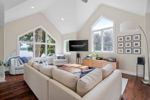 A bright and inviting living room overlooking a serene lake.