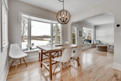 A modern dining space with large windows providing a scenic view.