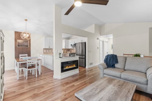 Your open-concept retreat features gleaming hardwood floors, vaulted ceilings, and a cozy fireplace perfect for unwinding after exploring.