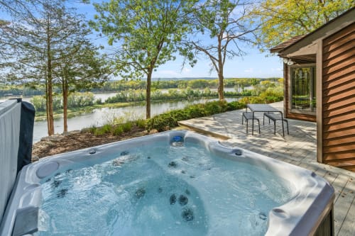 Soak in your private hot tub while watching the river flow by—pure bliss awaits.
