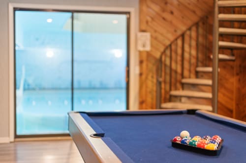 Challenge friends to pool while enjoying stunning lake views through floor-to-ceiling windows in your game room.