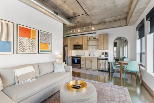 A stylish open-concept apartment featuring a modern living space and sleek kitchen.