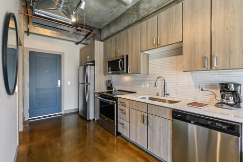 Your modern kitchen features sleek stainless steel appliances and warm wood cabinetry, perfect for preparing meals during your stay.