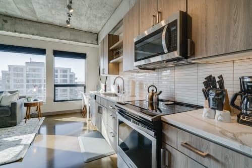 Your sleek kitchen features modern appliances and marble countertops, with city views creating the perfect backdrop for morning coffee.