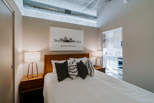 Your modern bedroom features a comfortable bed with stylish linens and warm ambient lighting for perfect rest.