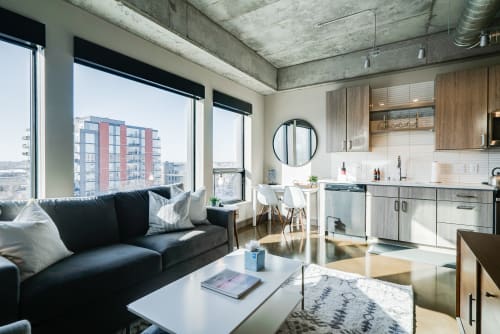 Settle into this stylish urban retreat where exposed concrete meets warm wood, and floor-to-ceiling windows frame vibrant city views.