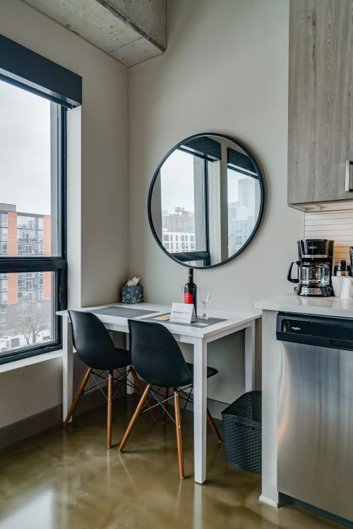 Your sleek dining nook with city views creates the perfect spot for morning coffee or casual meals.