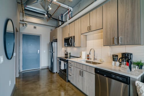 Your sleek galley kitchen features modern appliances and warm wood finishes, perfect for preparing meals during your stay.