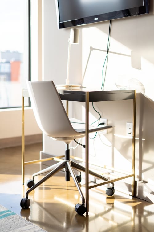 Your dedicated workspace features a sleek desk, ergonomic chair, and wall-mounted TV - perfect for catching up on work or relaxing with entertainment.