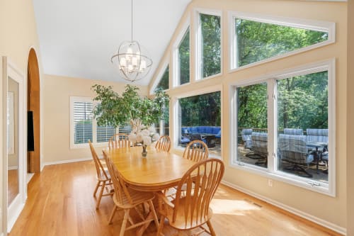 Bright and airy dining area with large windows and a view of the outdoors.