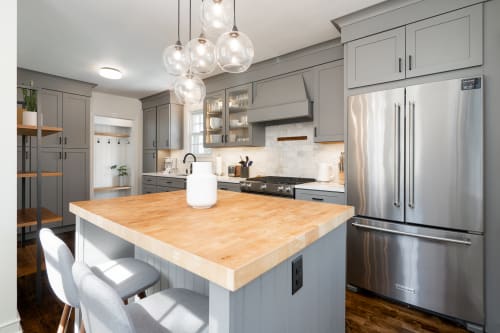 Your gourmet kitchen awaits with butcher block island, pendant lighting, and stainless steel appliances for memorable meal prep.